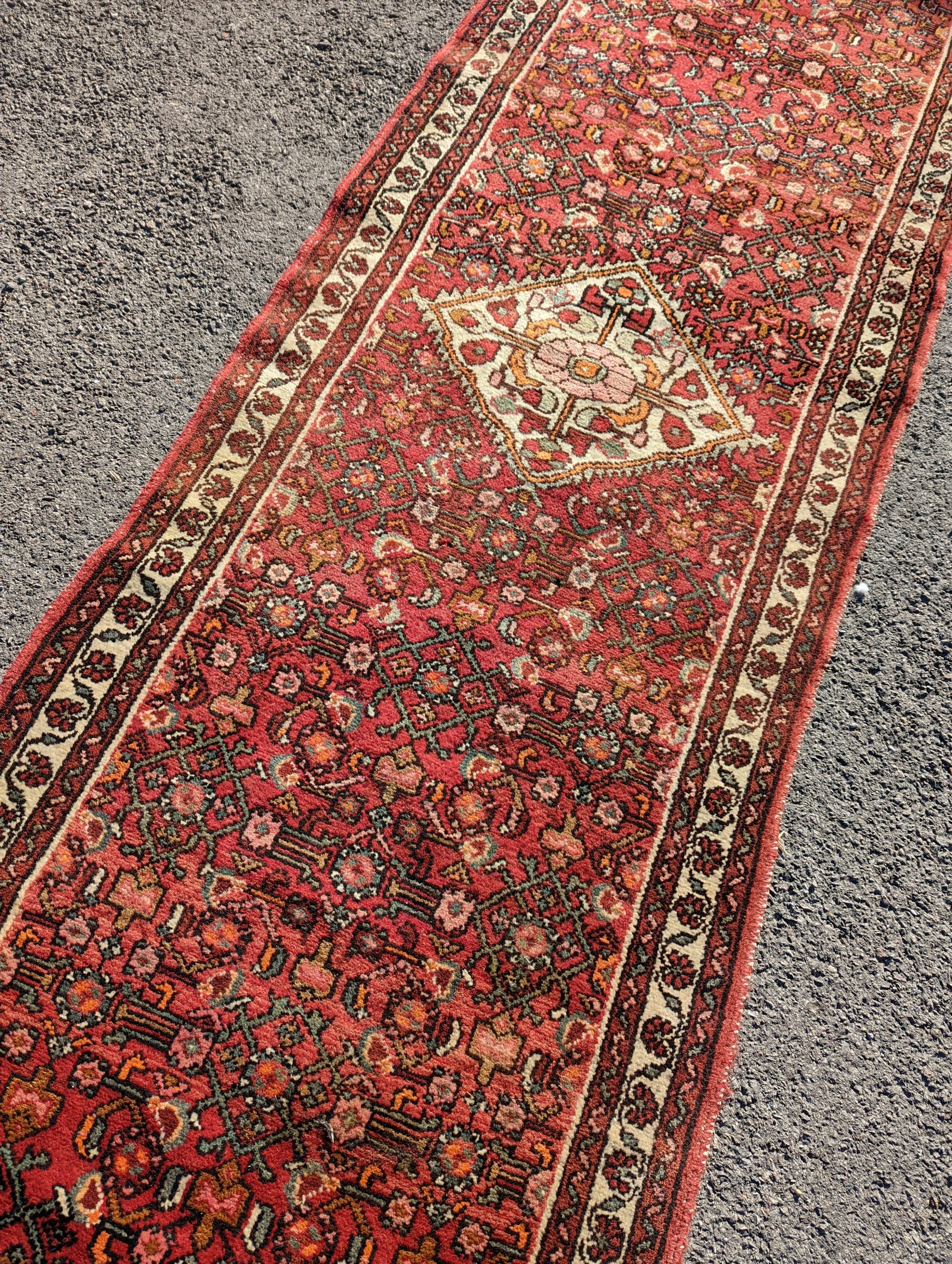 A North West Persian red ground runner, 290 x 82cm